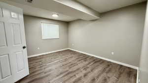 Below grade area featuring wood finished floors and baseboards