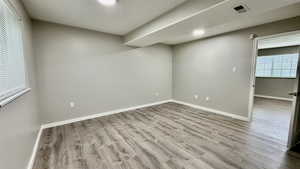 Unfurnished room featuring wood finished floors and baseboards
