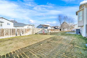 View of yard featuring a residential view and central AC unit