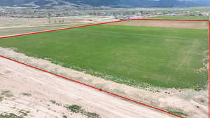 Aerial overview of property's location with property parcel outlined and a mountain backdrop