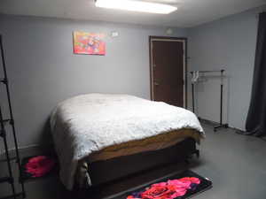 Bedroom featuring concrete flooring