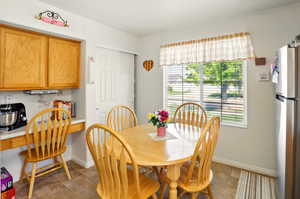 Dining area with plenty of natural light and baseboards