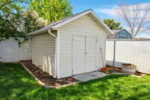 View of shed with fence