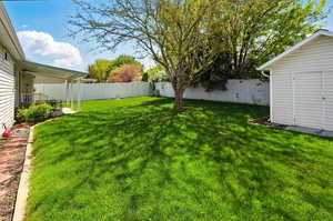 View of yard with an outdoor structure and a fenced backyard