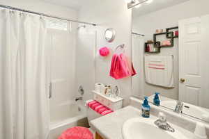 Full bathroom featuring shower / tub combo and vanity