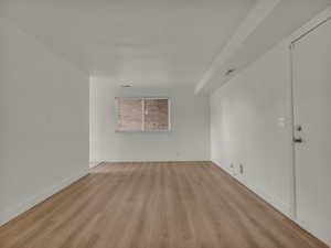 Unfurnished room featuring light wood-style floors and baseboards