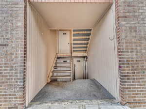 Doorway to property with brick siding