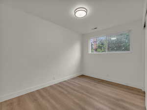 Empty room featuring light wood-type flooring and baseboards