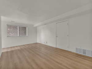 Empty room with light wood finished floors and baseboards