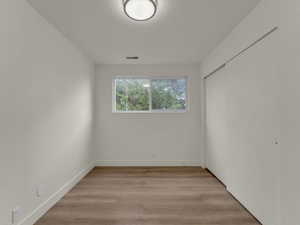 Unfurnished room with baseboards and light wood finished floors