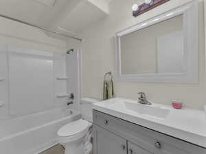 Full bathroom featuring toilet, vanity, and bathtub / shower combination