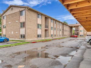 View of building exterior with uncovered parking