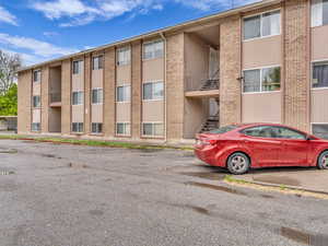 View of property featuring uncovered parking