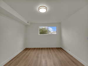 Empty room with light wood finished floors and baseboards
