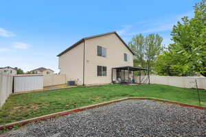 Back of property with central AC and a patio area