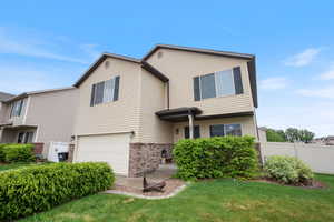 View of front of house featuring a garage and brick siding