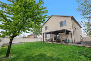 Back of property with a patio area and a gate