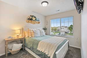 Carpeted bedroom with baseboards