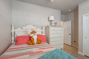 Bedroom featuring wood finished floors and baseboards
