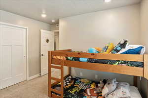 Bedroom with carpet flooring, baseboards, and recessed lighting
