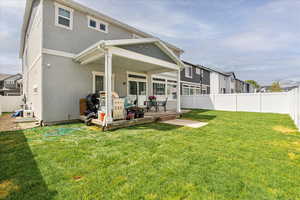 Back of property featuring stucco siding, a wooden deck, and a residential view