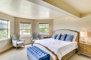 Bedroom with a textured ceiling, carpet floors, and baseboards