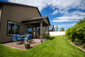 View of yard with a patio and a ceiling fan