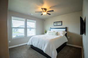 Bedroom with baseboards, carpet, and ceiling fan