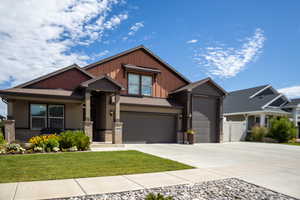 Craftsman-style house with driveway, board and batten siding, a garage, stucco siding, and a shingled roof