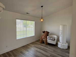 Living area with wood finished floors and baseboards
