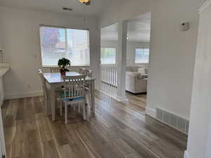Dining space with wood finished floors, lofted ceiling, and baseboards