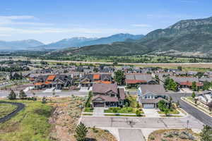 Drone / aerial view with a residential view and a mountain view, cul-de-sac borders open space
