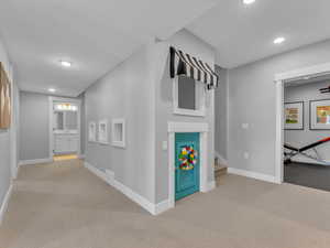 Hallway on lower level guides you to the additional bedrooms on this level