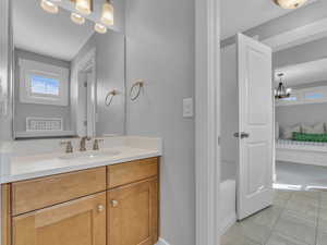 Full bath featuring vanity, ensuite bath, marble finish floor