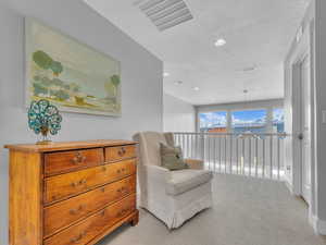 Loft sitting area featuring recessed lighting, mountain views, light colored carpet