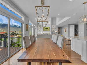 Dining space featuring recessed lighting, a chandelier, wood-style floors, and mountain views