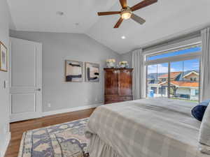 Bedroom featuring ceiling fan, baseboards, recessed lighting, vaulted ceiling, mountain views and wood finished floors