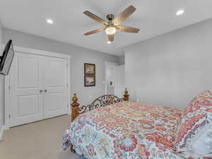 Bedroom featuring a ceiling fan and large closet