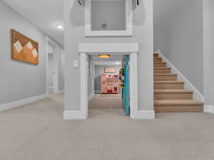 Stairwell to lower level and playful kids area