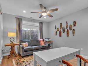 Office area with a ceiling fan, light wood-style flooring, recessed lighting,