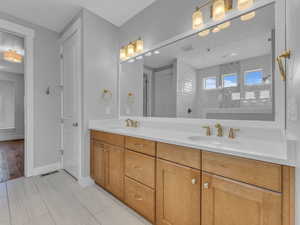 Full bathroom with double vanity, and a sink