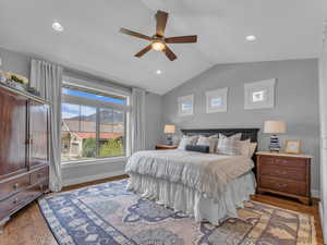 Bedroom with recessed lighting, a ceiling fan, vaulted ceiling, mountain views and wood finished floors