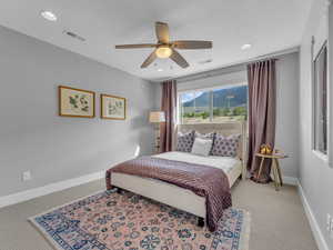 Bedroom with carpeting, mountain views and recessed lighting