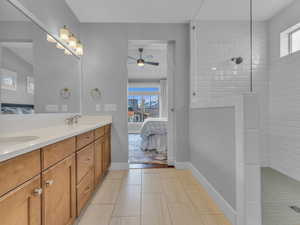 Ensuite bathroom with oversized walk in shower, double vanity, and a sink
