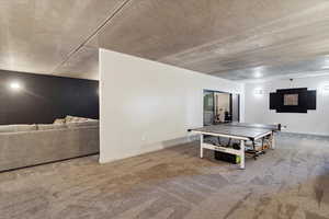 Game room featuring carpet and baseboards