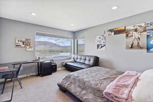Bedroom featuring carpet flooring, recessed lighting, and a water view