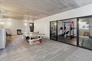 Recreation room featuring carpet floors and baseboards