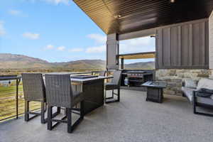 Balcony with a mountain view, a patio area, and a fire pit