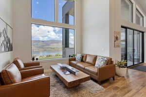Living area with a high ceiling, wood finished floors, and a mountain view