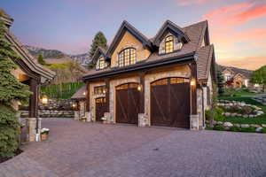 Garage with a mountain view and decorative driveway
